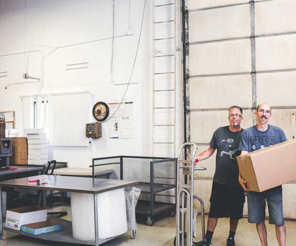 warehouse workers posing for photo in warehouse