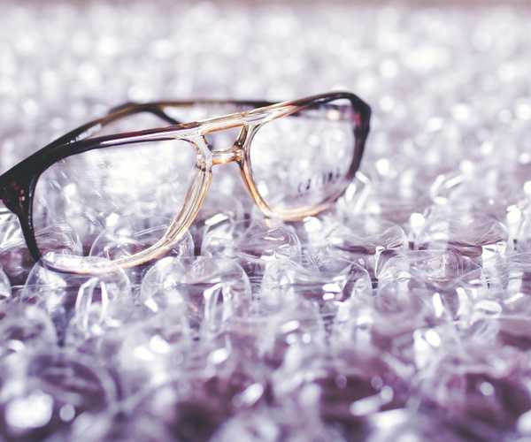 pair of eyeglasses sitting on bubble wrap