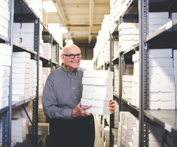 i-deal optics team member holding boxes of eyeglasses